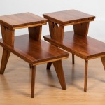 Pair of Hawaii Modern side tables in koa with ape carvings.